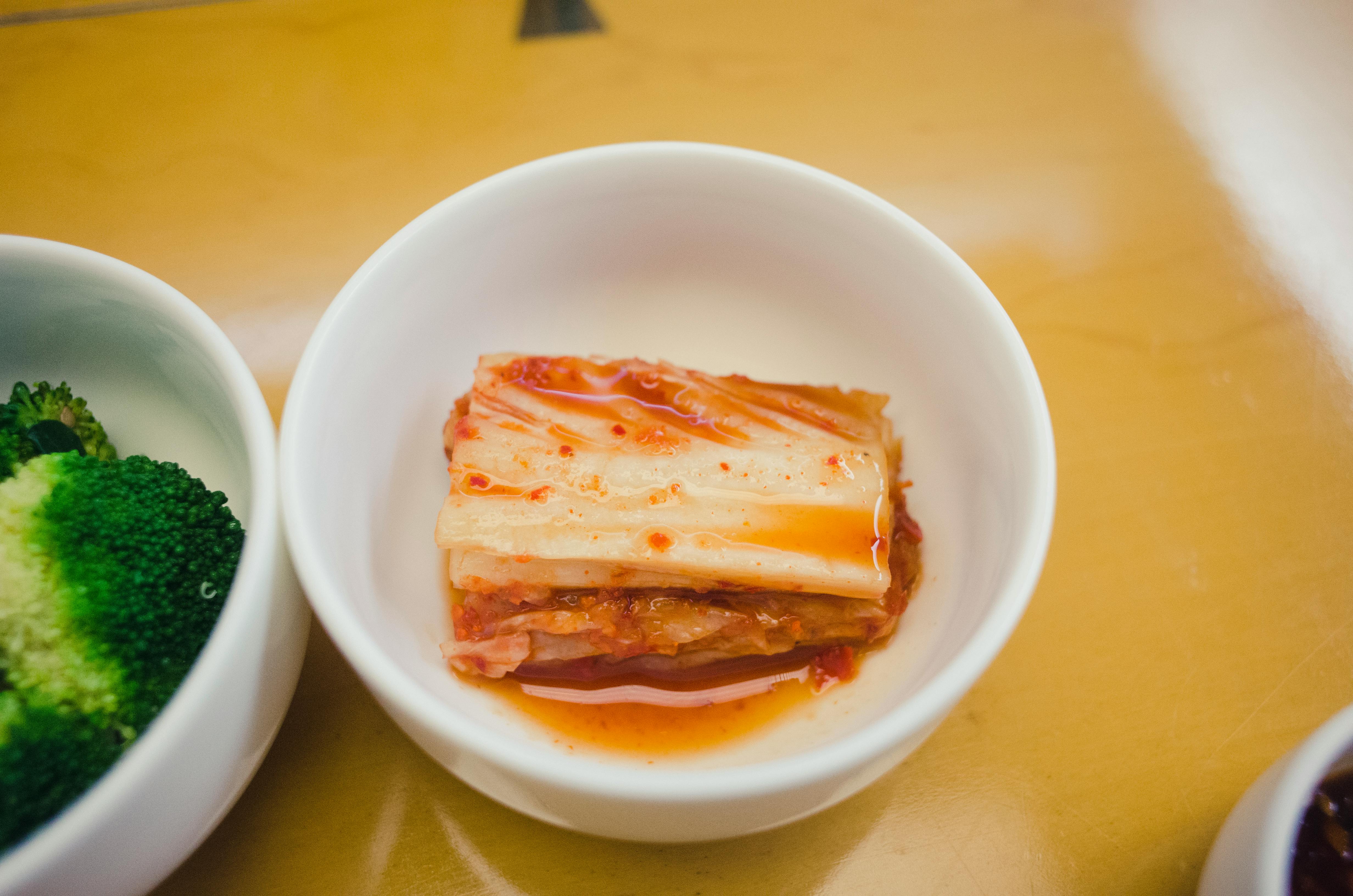 Stacked sheets of Korean seasoned seaweed snack on minimal grey backdrop